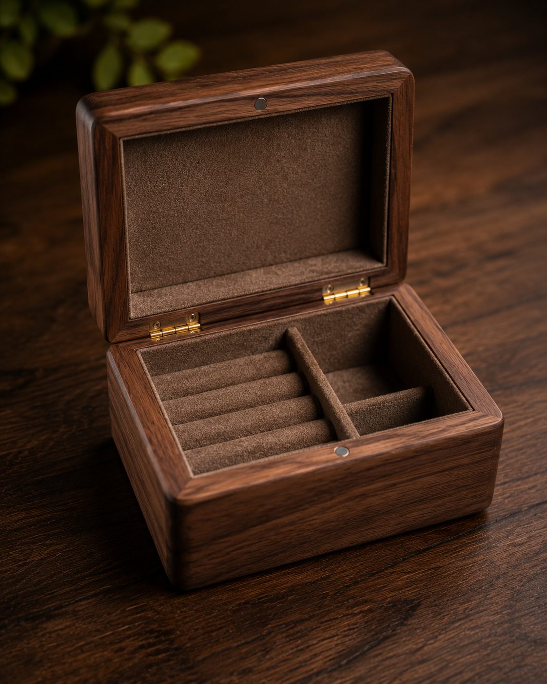 Open walnut jewelry box with felt-lined compartments and brass hinges